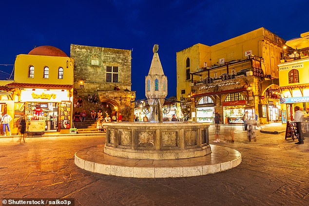 Sunset in the main square in Rhodes' Old Town is a tourist favourite...but holidaymakers have warned it can also leaver drinkers out of pocket, as bars inflate prices