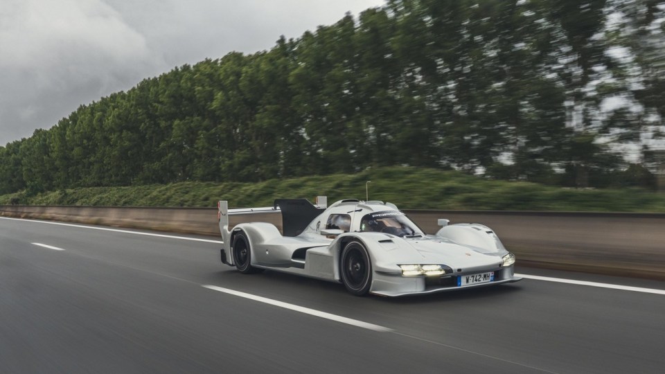 Porsche 963 RSP driving on a highway.
