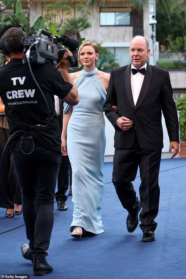 Charlene channelled her late-mother-in-law Grace Kelly as she stepped out in a sky blue halterneck ballgown that elegantly fell to the floor paired with silver heels, oozing old Hollywood glamour
