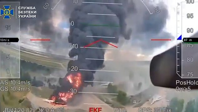 A column of flames and black smoke rises over a targeted plane during Ukraine's Operation Spiderweb