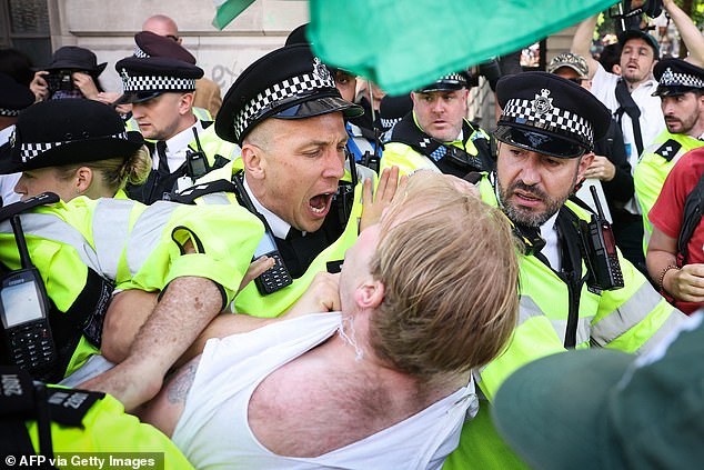Police officers and Palestine Action protesters clash in Trafalgar Square, central London