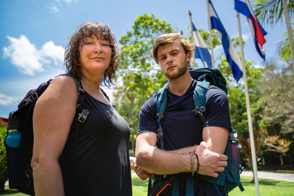Photo of a mother and son with backpacks, standing outdoors.