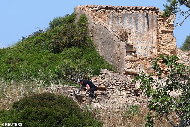 A criminal police investigator searches the area near a ruin as police resumes the search for the body of Madeleine McCann, who went missing in the Portuguese Algarve in May 2007, in Atalaia, Portugal, June 5, 2025