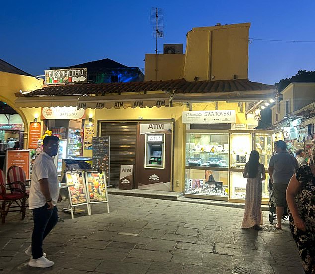 Another ATM seen in the main Hippocrates Square. The square is bustling with people shopping at souvenir shops and dining in at the many restaurants, some of which have scathing reviews