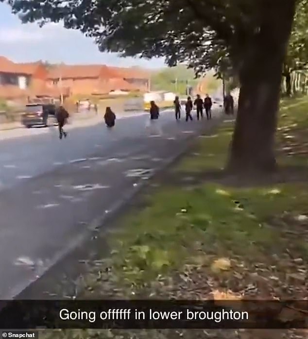 Riots have reportedly erupted in Salford after a gang of youths set a vehicle on fire and assaulted a police officer