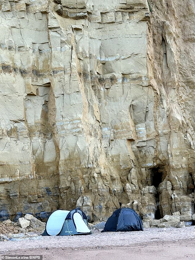 Reckless campers risked their lives by pitching their tents under a dangerous cliff on the Jurassic Coast