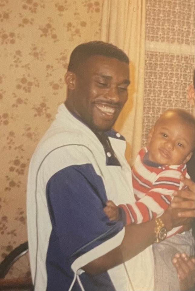 Alex Iwobi holding a baby.