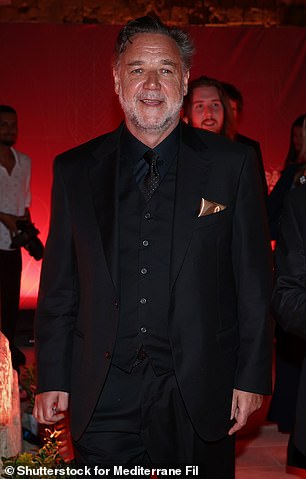 Russell Crowe cut a dashing figure when he attended the Golden Bee Awards in Malta on Sunday. The 60-year-old was looking trim and terrific in an all-black look that consisted of an immaculately tailored suit paired with a crisp black dress shirt and vest. Pictured