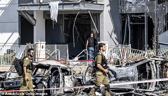 BEERSHEBA, ISRAEL - JUNE 20: Israeli police officers and bomb disposal experts are seen working at the impact site after a missile reportedly launched from Iran struck the southern Israeli city of Beersheba on June 20, 2025. Authorities began investigations following the incident as part of broader security measures amid ongoing regional tensions. (Photo by Mostafa Alkharouf/Anadolu via Getty Images)