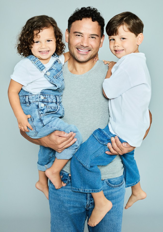 Ryan Thomas holding his two children.