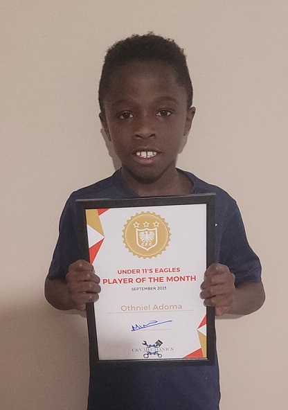 Othniel Adoma holding his Under 11's Eagles Player of the Month award.