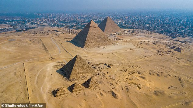 The three pyramids in Giza are shrouded in mystery due to their unclear construction methods, precise astronomical alignment, and still-debated purpose