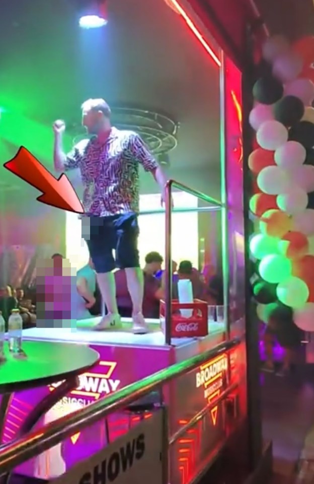 A man urinating from a bar podium in Benidorm.