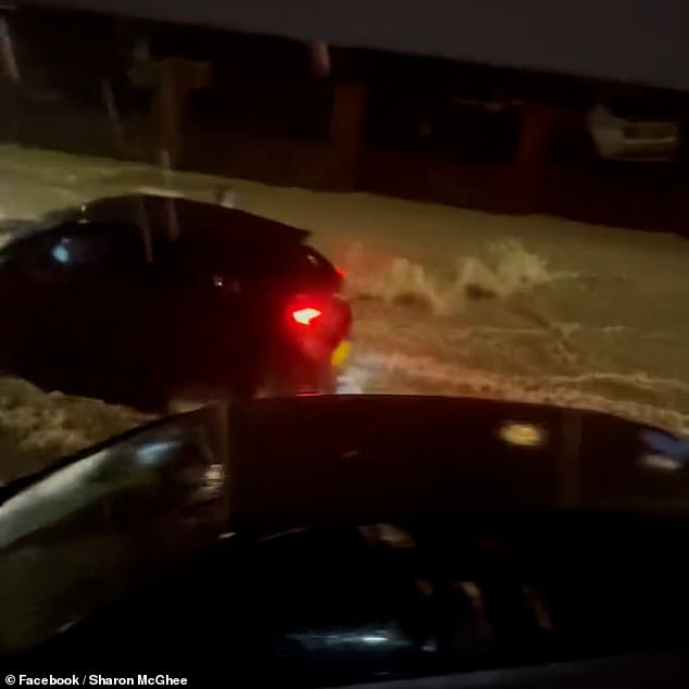 Dramatic footage taken in Dover last night shows an intense stream of water flowing down a residential road, before a moving car with its hazard lights on comes into view