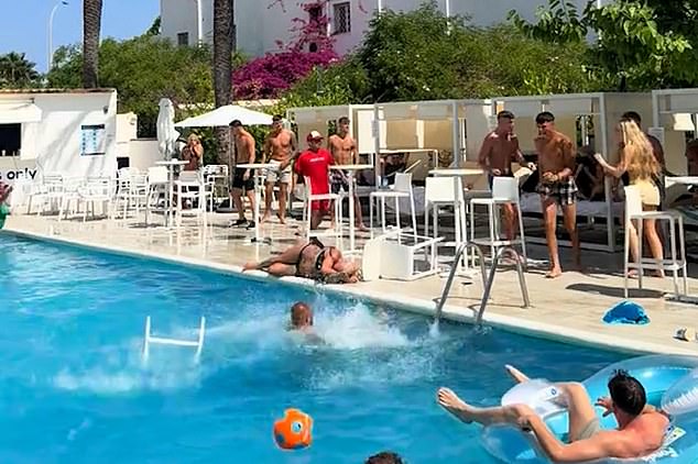 A chaotic poolside brawl broke out at a hotel in Ibiza leaving one women unconscious after she was hit in the head with a chair