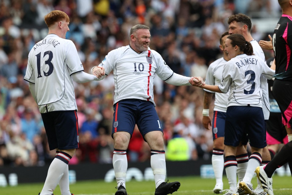 England's former footballer Wayne Rooney (C) celebrates with teammates after scoring the opening goal during the England XI v World XI charity football match for Soccer Aid for Unicef at Old Trafford in Manchester, north-west England on June 15, 2025. (Photo by Darren Staples / AFP) (Photo by DARREN STAPLES/AFP via Getty Images)