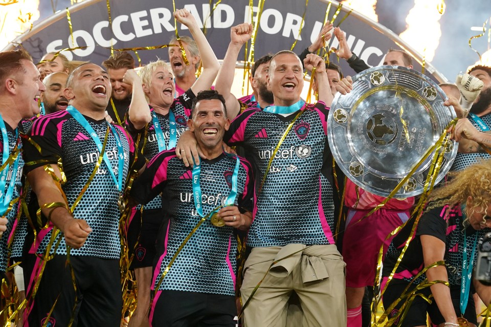 World XI team celebrating Soccer Aid for UNICEF victory with trophy.