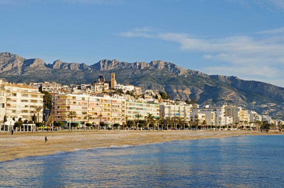 Altea, Spain coastline with buildings and mountains in the background.