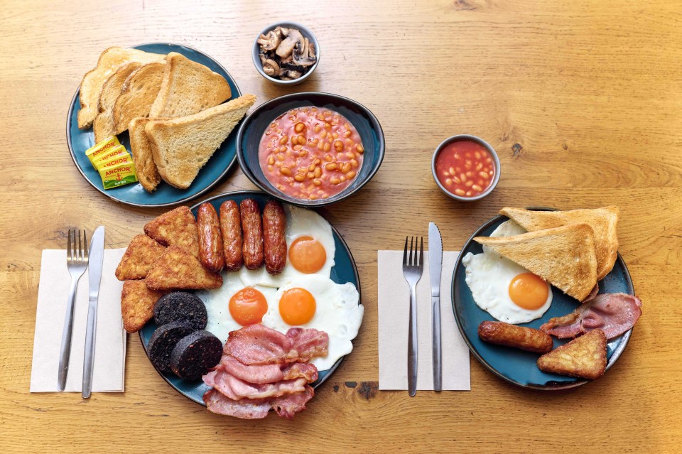 Full English breakfast on a wooden table.