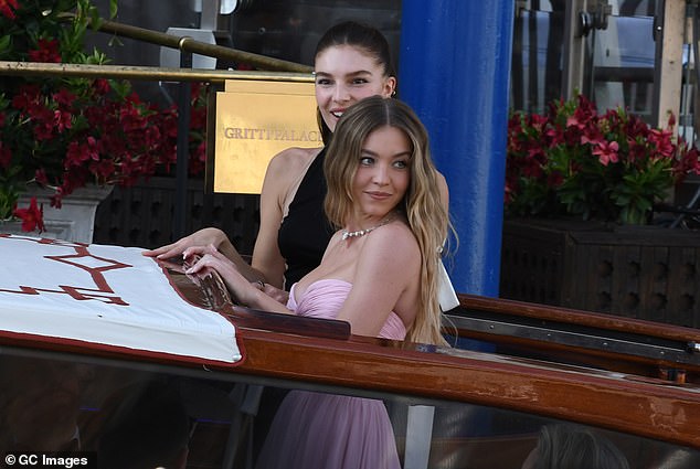 The 27-year-old actress slipped into a pink dress for the evening as she was pictured on a Venetian taxi boat on her way to the wedding on Friday