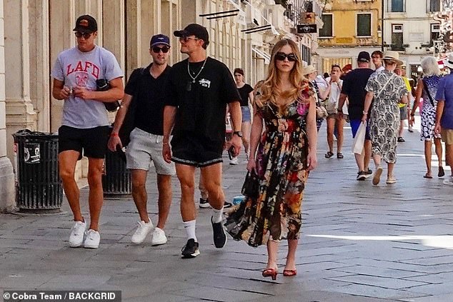 Sydney Sweeney was spotted enjoying a stroll through the sun-soaked streets of Venice with Orlando Bloom (centre) and Tom Brady (left) on Saturday