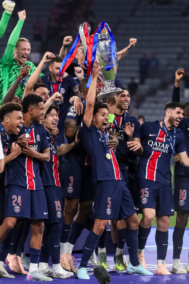 Paris Saint-Germain players celebrating with the UEFA Champions League trophy.