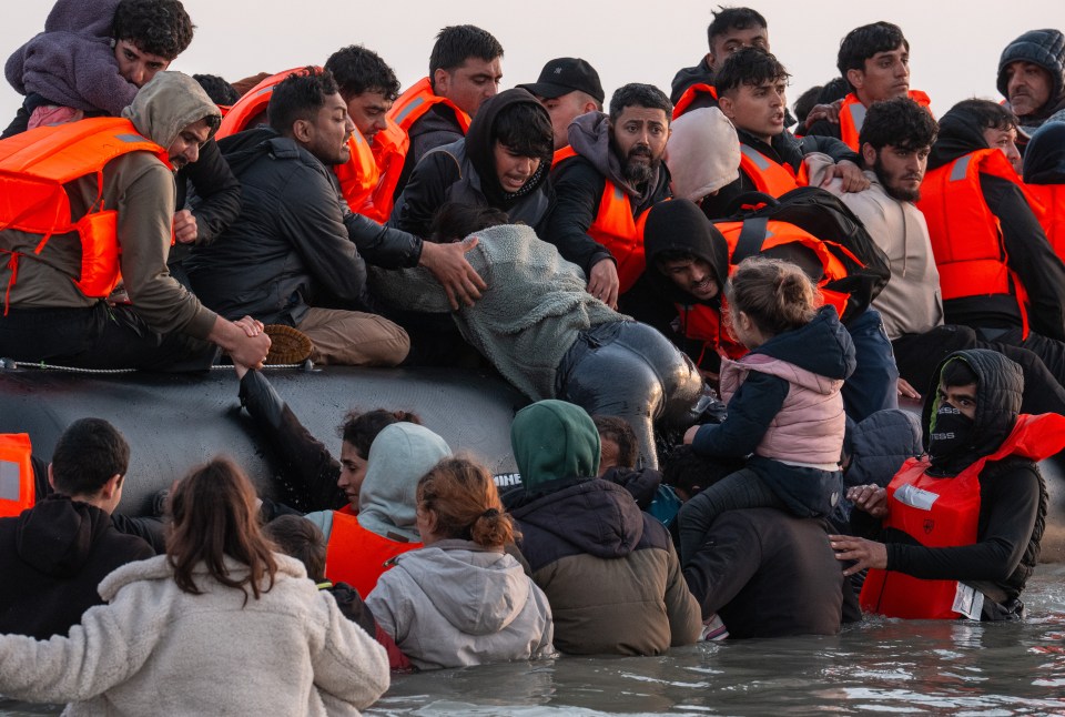 Migrants arriving in a small boat.