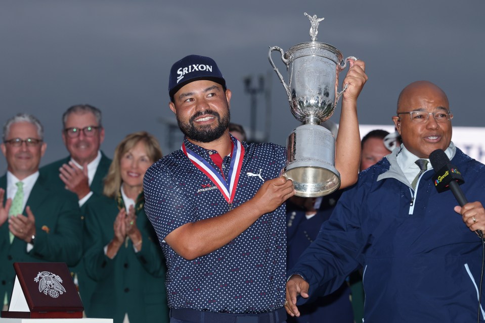 J.J. Spaun holding the U.S. Open trophy.