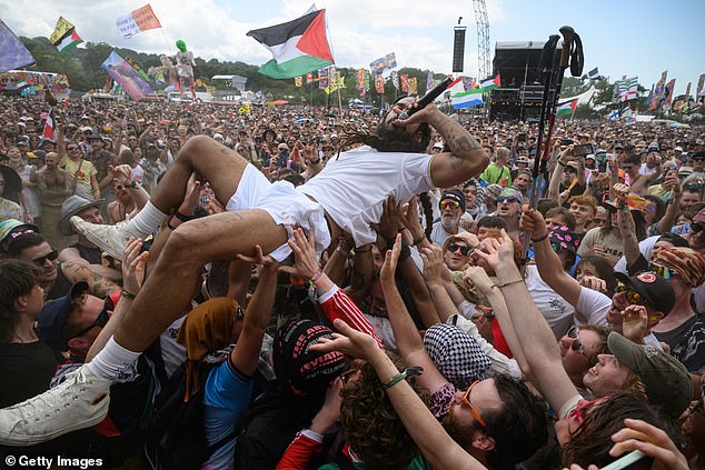 In appalling scenes condemned by the British and Israeli governments, the lead singer of the duo Bob Vylan (pictured crowdsurfing) led a crowd of thousands in a vile chant of 'death, death to the IDF' – the Israel Defence Forces