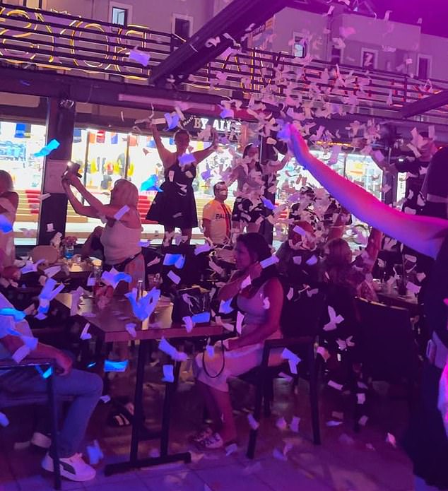 A bar on the vibrant Armutalan Street just minutes before midnight, with flying confetti and customers dancing on chairs