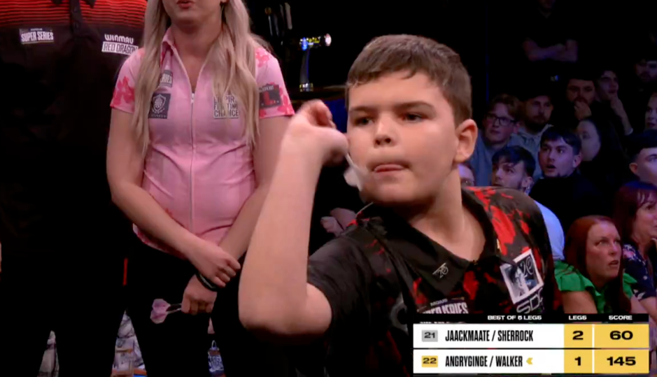 Young boy throwing darts in a competition.