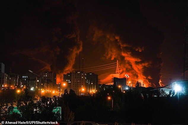 Fire and smoke rise into the sky after an Israeli attack on an oil depot in Tehran, Iran, at dawn on Sunday, June 15, 2025