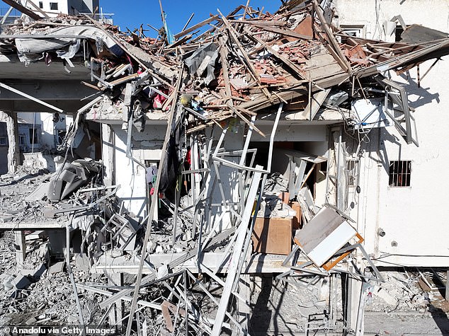 Tens of thousands of British citizens were trapped in a war zone tonight as officials admitted an evacuation from Israel is currently impossible. Above, the destruction after Iranian airstrikes in Ramat Gan near Tel Aviv, Israel