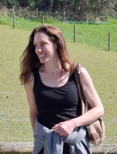 Woman smiling outdoors.