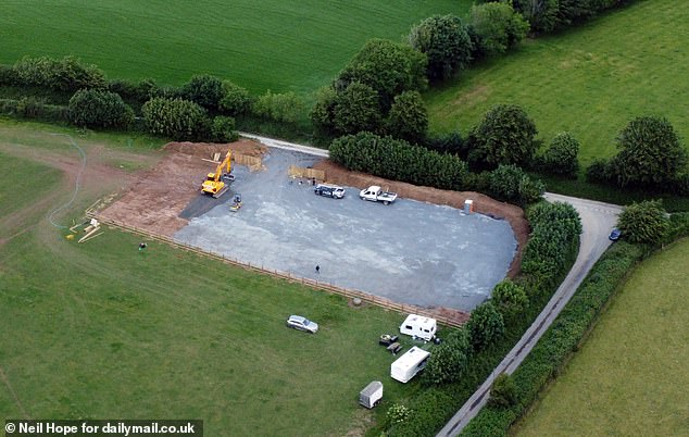 A field in a rural patch of north Devon countryside has been ripped apart by bulldozers and turned into a suspected traveller camp (pictured on Wednesday)