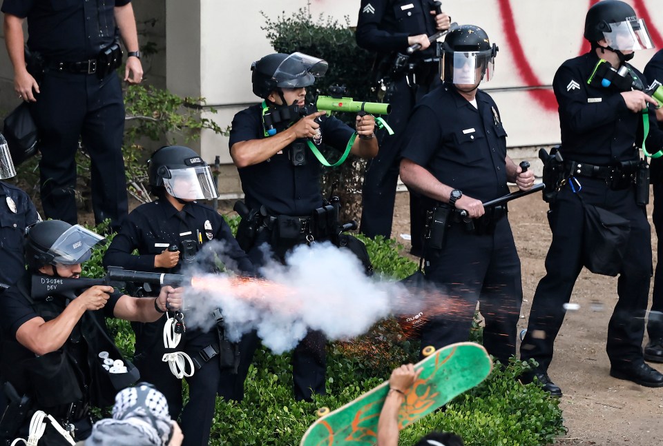 LAPD officers firing less-lethal projectiles at protesters.