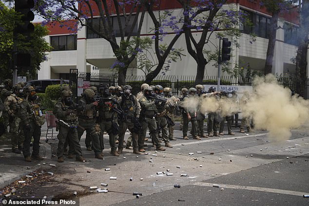 Border Patrol personnel deploy tear gas during a demonstration over the dozens detained in an operation by federal immigration authorities a day earlier in Paramount