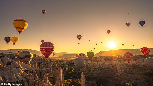Hot air balloons over Cappadocia, effervescing upwards like champagne bubbles