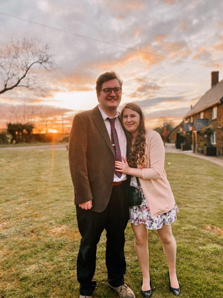 Photo of a couple embracing at sunset.