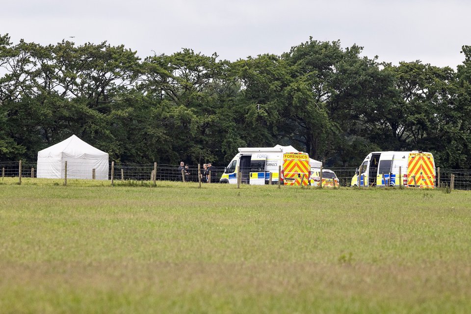 Police and forensic vehicles at a skydiving accident scene.