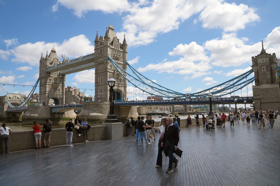People walking near Tower Bridge in London.