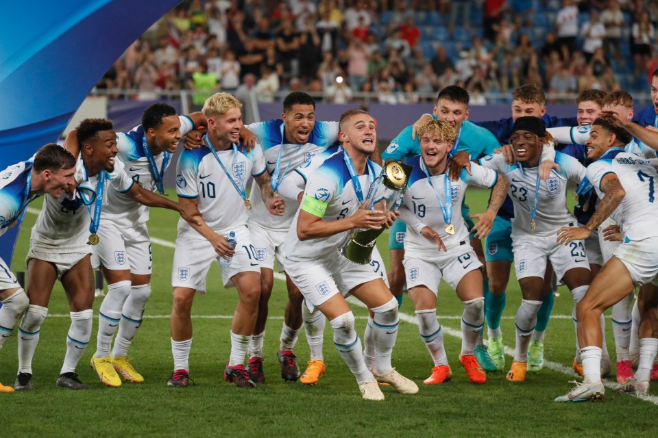 Taylor Harwood-Bellis of England lifts the UEFA Under-21 Euro 2023 trophy.