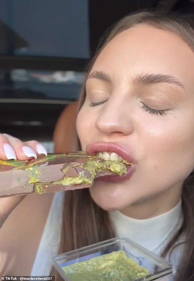 The bar went viral after Maria Vehera (pictured) shared a video of herself sinking her teeth into the sweet treat, oozing with gooey green filling made from sweet filo and pistachio