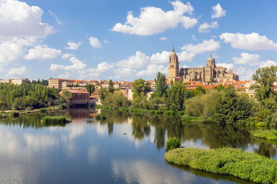The New Cathedral of Salamanca reflected in the Tormes River.