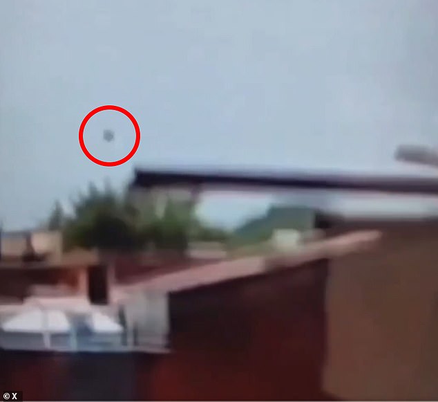 The mysterious piece of debris that flew off the plane into the air is circled here just as the London-bound Boeing 787-8 Dreamliner disappeared from view and crashed