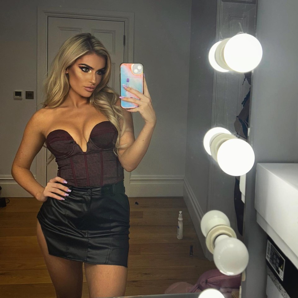 Selfie of Mariah May, AEW wrestler, in a corset and leather skirt.