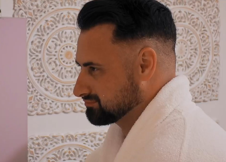 Man in a white bathrobe.