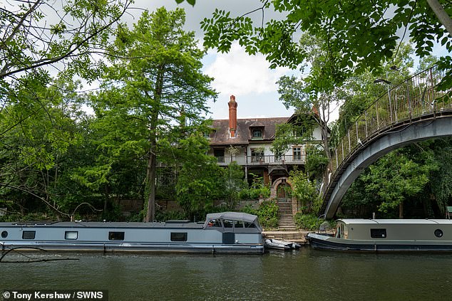 A couple who briefly considered downsizing their home have made a dramatic U-turn - by splashing the cash on a River Thames private island mansion, pictured