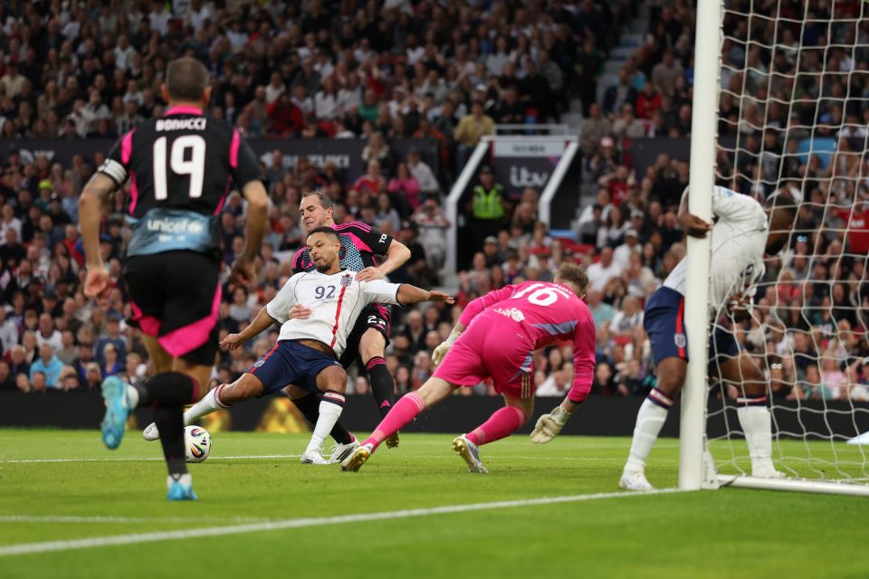 Soccer player scoring a goal during a match.