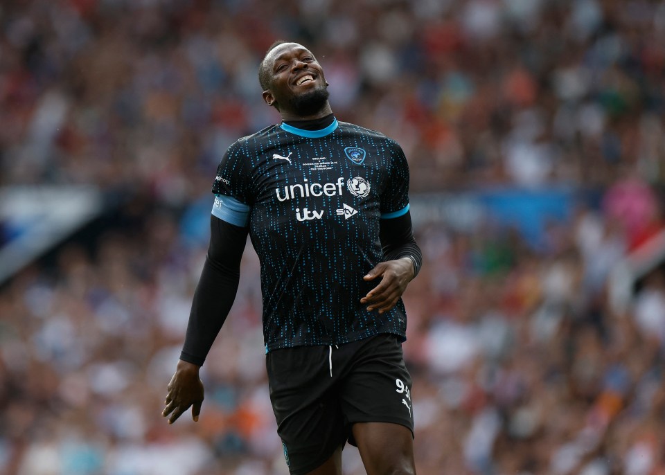 Usain Bolt smiling at a Soccer Aid match.